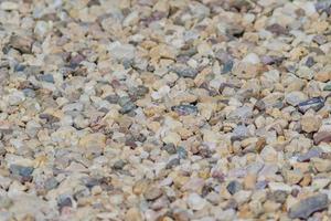 texture de fond de gravier. gros plan de petites pierres sur le sol. mise au point sélective. photo