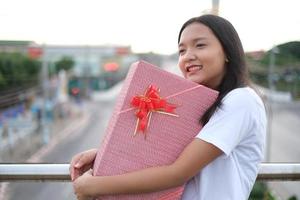 heureuse jeune fille avec boîte-cadeau. photo