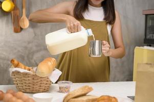 gros plan sur une belle jeune femme cuit dans sa cuisine, sa boulangerie et son café photo