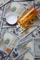 bangkok thaïlande 07 janvier 2022 pilules et flacons de pilules éparpillés sur des billets en dollars américains.