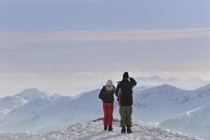 couple de snowboarders au sommet de la montagne photo