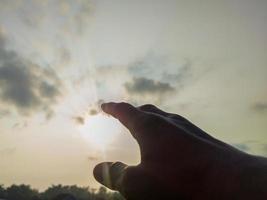 photo de mains qui veulent toucher le soleil