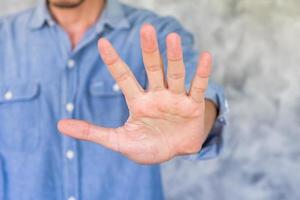 jeune homme montrant le signe de la main de la paume. photo