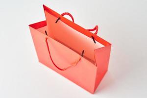 vue de dessus à l'intérieur d'un sac à provisions en papier rouge ouvert sur fond blanc. photo