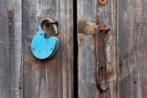 vieux bleu cadenas déverrouillé rouillé sur porte en bois photo