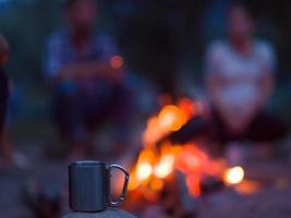 jeunes amis se détendant autour d'un feu de camp photo