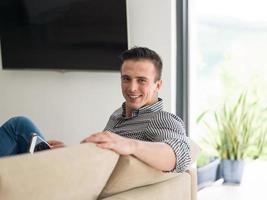 homme sur un canapé à l'aide d'une tablette photo