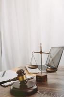 concept de justice et de droit. juge masculin dans une salle d'audience sur une table en bois et conseiller ou avocat masculin travaillant au bureau. concept de droit, de conseil et de justice juridique. photo