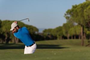 golfeur professionnel frappant un coup de bunker de sable photo