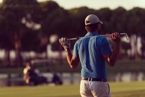 golfeur de dos au cours à la recherche d'un trou à distance photo