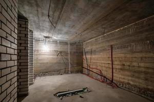 sous-sol vide non meublé avec un minimum de réparations préparatoires. intérieur aux murs de briques blanches photo