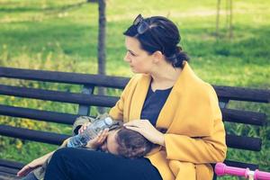 mère et fille reposant sur un banc dans le parc. photo