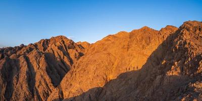 panorama dans la chaîne de montagnes du sinaï egypte semblable aux paysages martiens avec des ombres de personnes photo