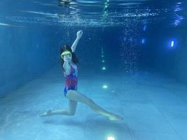 enfant souriant avec des lunettes de natation, plongez dans la piscine avec plaisir - sautez profondément sous l'eau. mode de vie sain, activité de sports nautiques les étés. photo