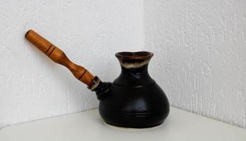 cafetière en céramique vide vintage avec manche en bois, isolée sur fond blanc photo