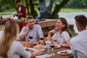 amis ayant pique-nique dîner français en plein air pendant les vacances d'été photo