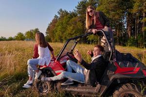 groupe de jeunes gens heureux profitant d'une belle journée ensoleillée tout en conduisant une voiture buggy hors route photo