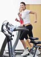 womanworkout dans un club de remise en forme sur la machine de piste de course photo