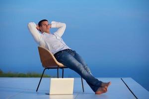 jeune homme détendu à la maison sur le balcon photo