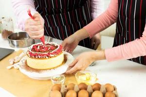 une femme asiatique et un homme arabe en tant que jeune couple adulte apprennent à cuisiner en ligne un gâteau de cuisson à la boulangerie. vidéo familiale diversifiée à la classe de cyberespace sur ordinateur portable en tant que blogueur médias sociaux ensemble, espace de copie photo