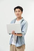 image d'un jeune homme séduisant portant des vêtements décontractés tenant et utilisant un ordinateur portable ouvert isolé sur fond blanc photo
