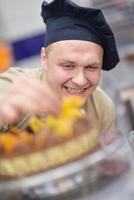 chef préparant le gâteau du désert dans la cuisine photo