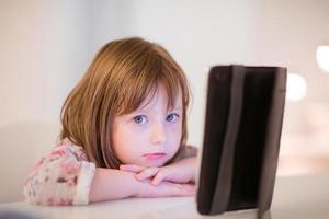 enfant qui joue avec une tablette numérique photo