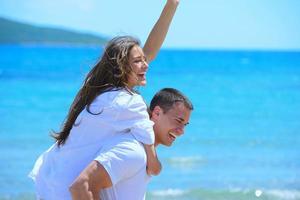 un couple heureux s'amuse sur la plage photo