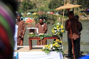 dieng, indonésie - 1er août 2015. festival de la culture dieng, les touristes suivent la procession des dreadlocks lors de l'événement du festival de la culture dieng à dieng, district de banjarnegara, java central photo