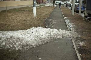 neige sur la route. un tas de neige se trouve sur l'asphalte. photo