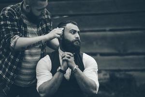 coiffeur rase un homme barbu photo