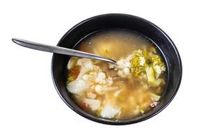 soupe de stellines et de légumes dans un bol avec une cuillère photo