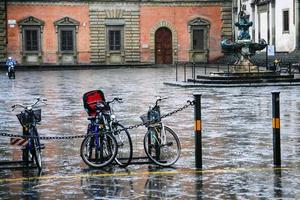 Vélos mouillés sur la piazza della santissima annunziata photo