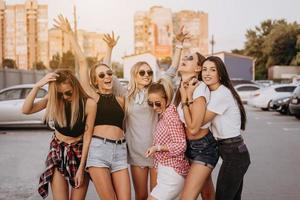 six jeunes femmes s'amusent au parking. photo