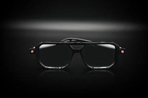 lunettes de soleil carrées dans un cadre en plastique noir isolé sur noir photo