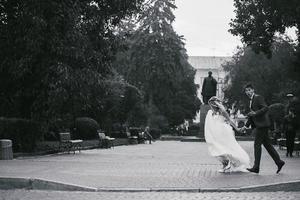 le marié tient la mariée dans ses bras et tordu photo