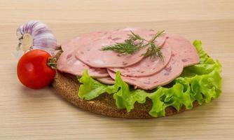 saucisse de boeuf sur planche de bois et fond de bois photo