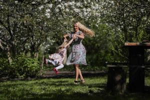 mère torsion fille dans le jardin photo