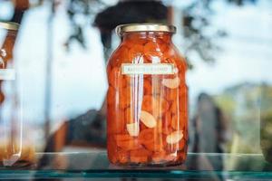 dans la fenêtre se trouve une boîte fermée de deux litres de carottes marinées. photo