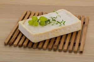 Fromage brie sur planche de bois et fond de bois photo