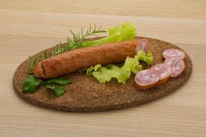 saucisse sur planche de bois et fond en bois photo