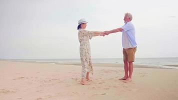 couples heureux debout et main dans la main sur la plage. photo