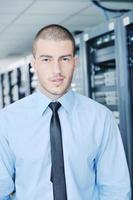 jeune ingénieur informatique dans la salle des serveurs du centre de données photo