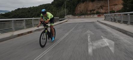 athlète de triathlon faisant du vélo lors de l'entraînement du matin photo