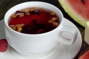 thé à la framboise rouge avec des morceaux de fruits et de baies photo