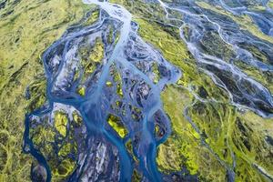 motif abstrait de rivières glaciaires bleues qui coule à travers le champ de mousse volcanique dans les hautes terres islandaises en été photo