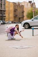 belle jeune femme assise au milieu du trottoir photo