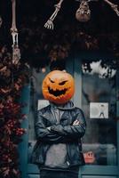 gars avec une tête de citrouille pose pour la caméra photo