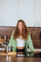 portrait en gros plan d'une femme souriante heureuse dans la cuisine regardant directement la caméra photo