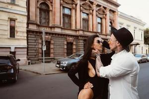 un jeune couple d'amoureux sexy pose devant un appareil photo dans la rue